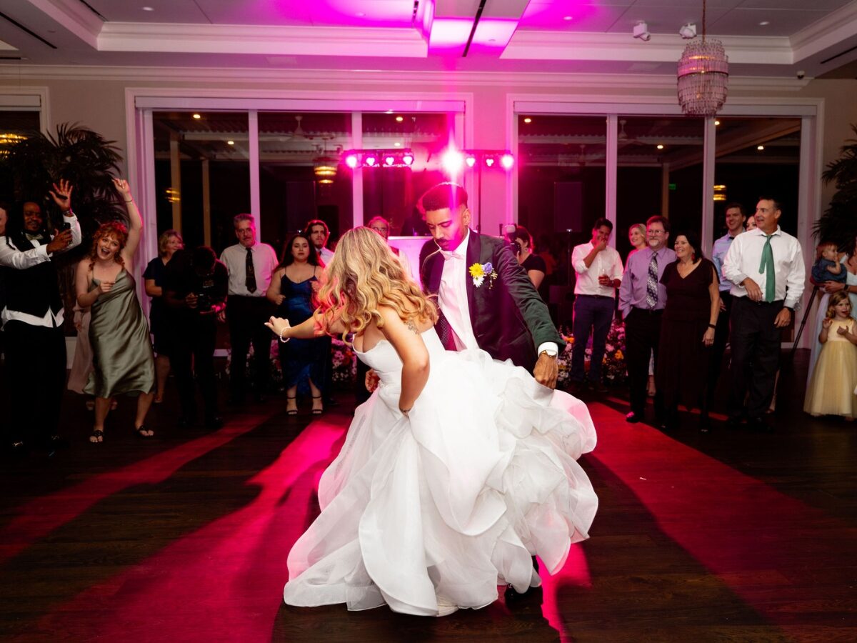A couple dancing the night away under the dance floor lighting