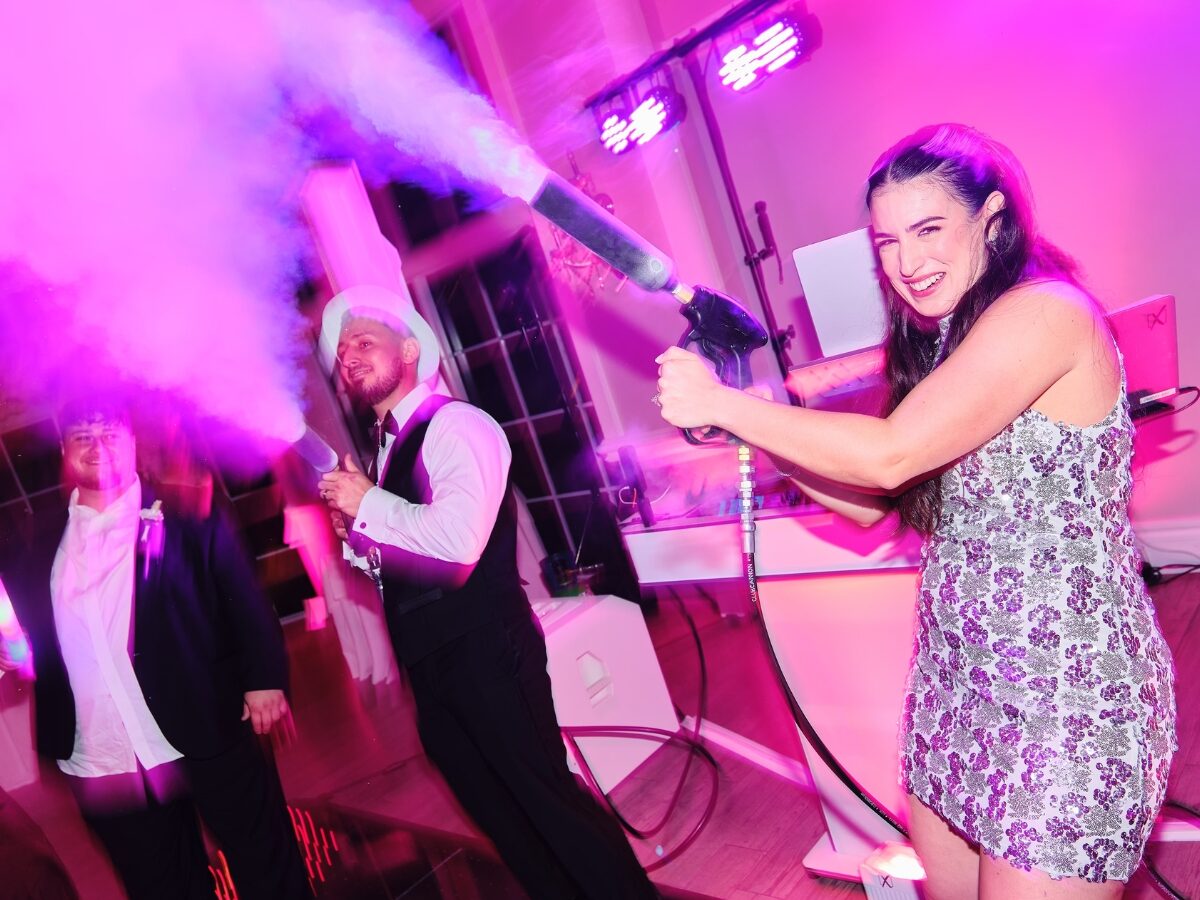 Newlyweds blasting CO2 guns in front of the DJ booth