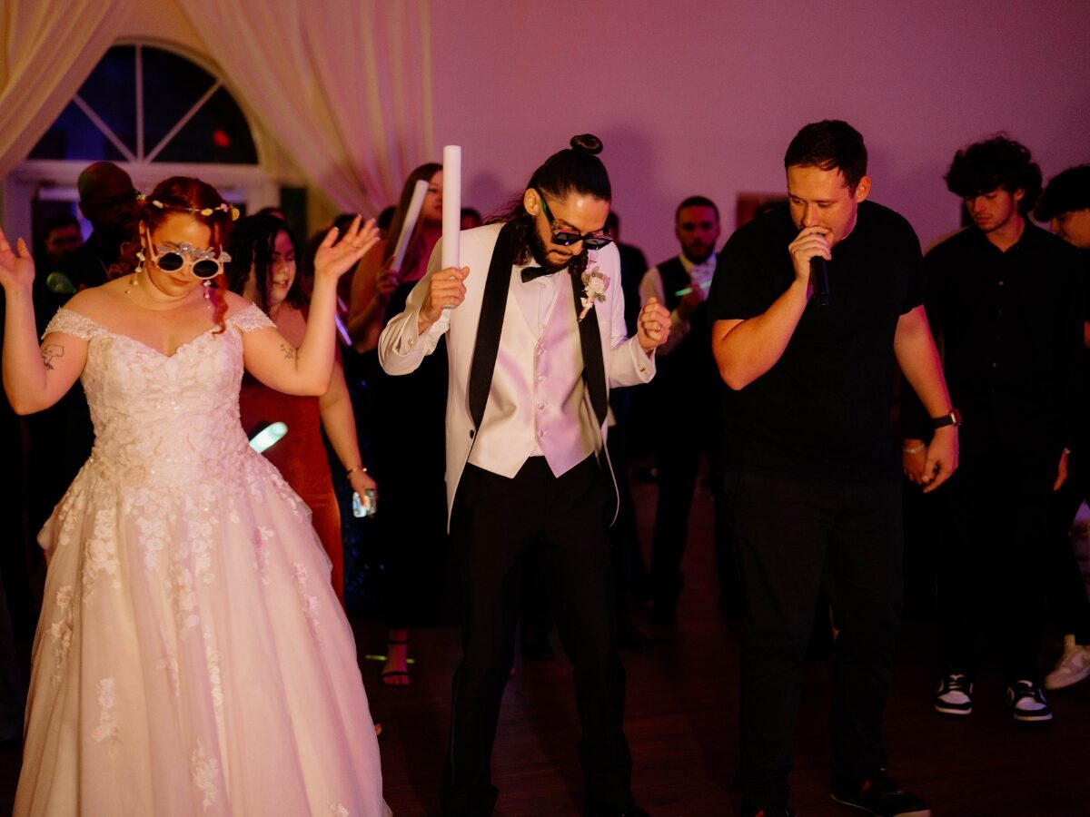 Drew Segura dancing with newlyweds on the dance floor at Vista Lago Ballroom