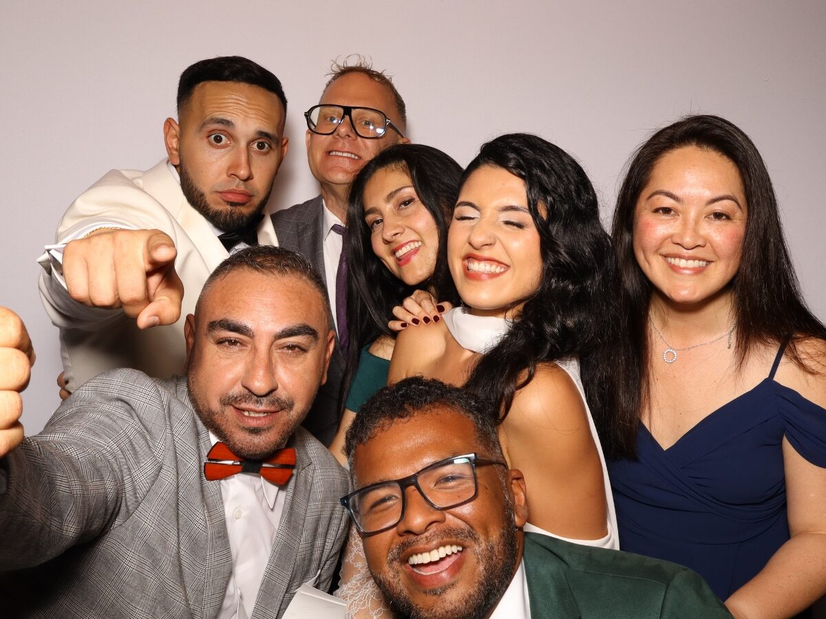 Wedding guests laughing together in the Lux photo booth
