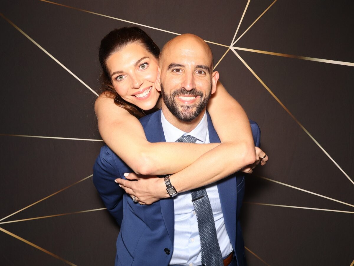 Bride and groom striking a pose in the open-air photo booth