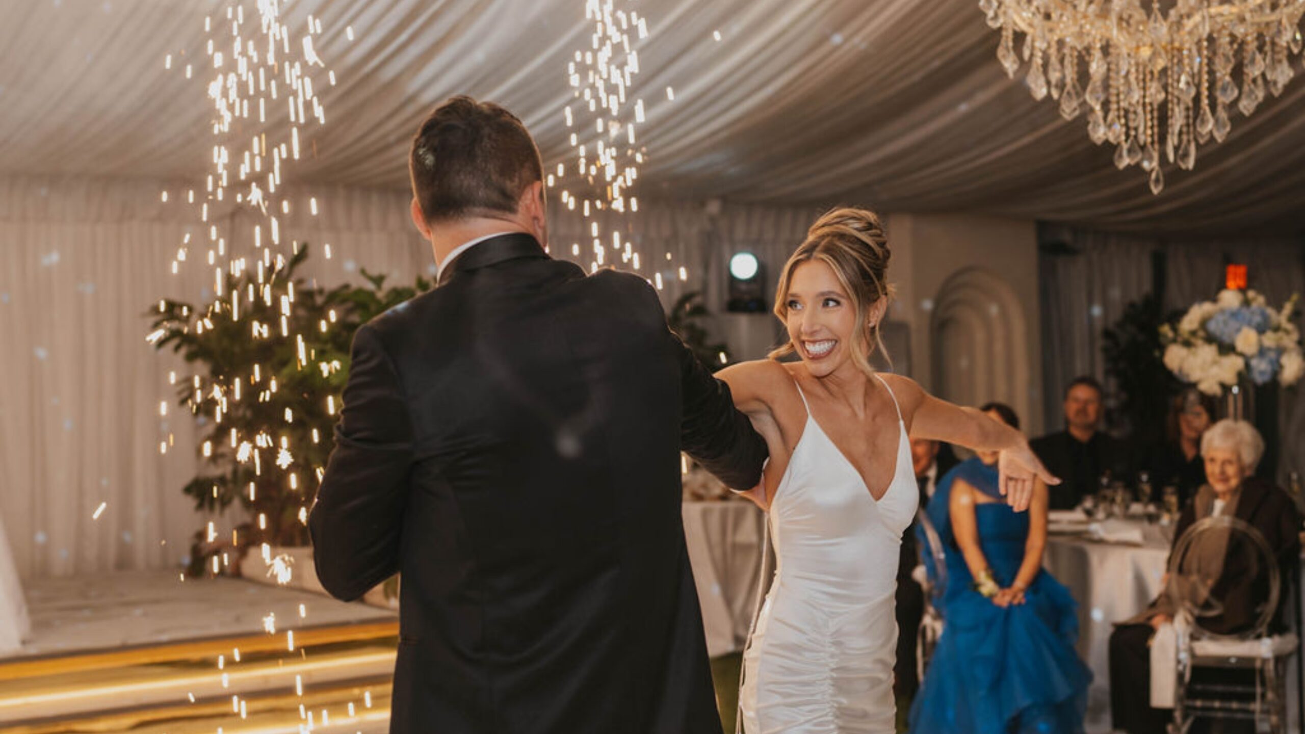 Couple dancing as cold sparks fly behind them at a South Florida wedding
