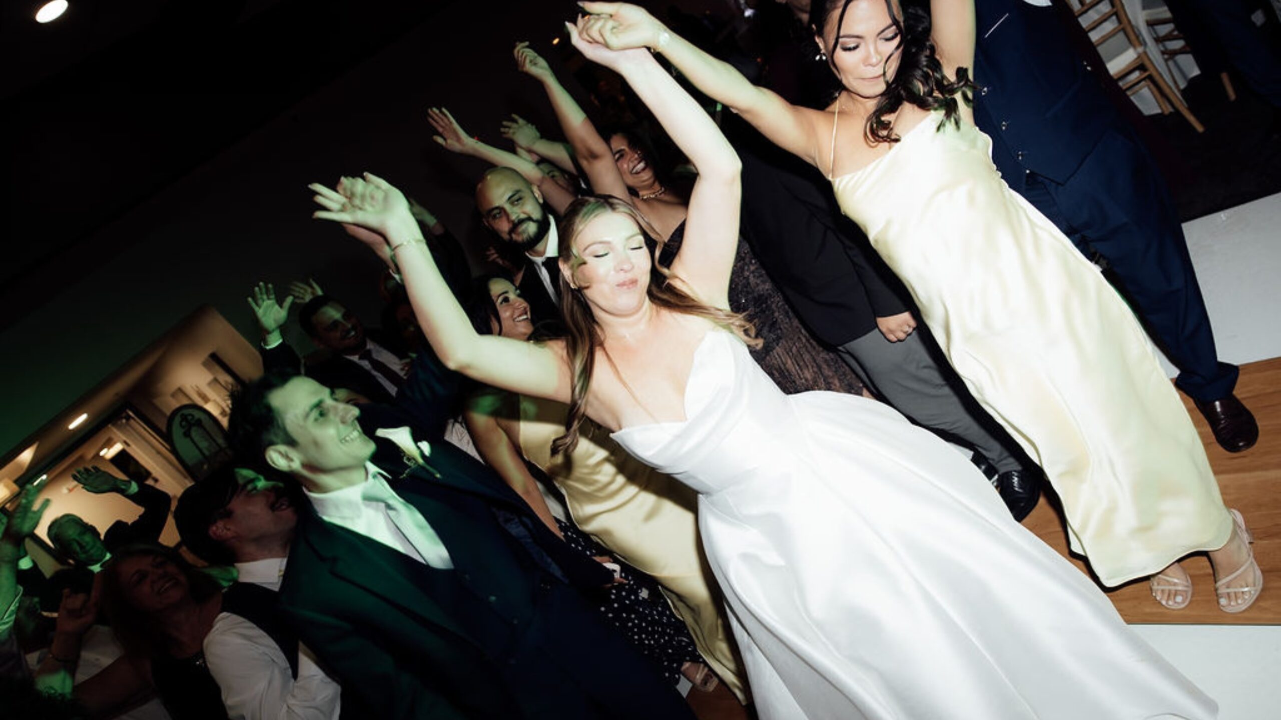 Bride and groom dancing with guests at their Jupiter, Florida wedding reception
