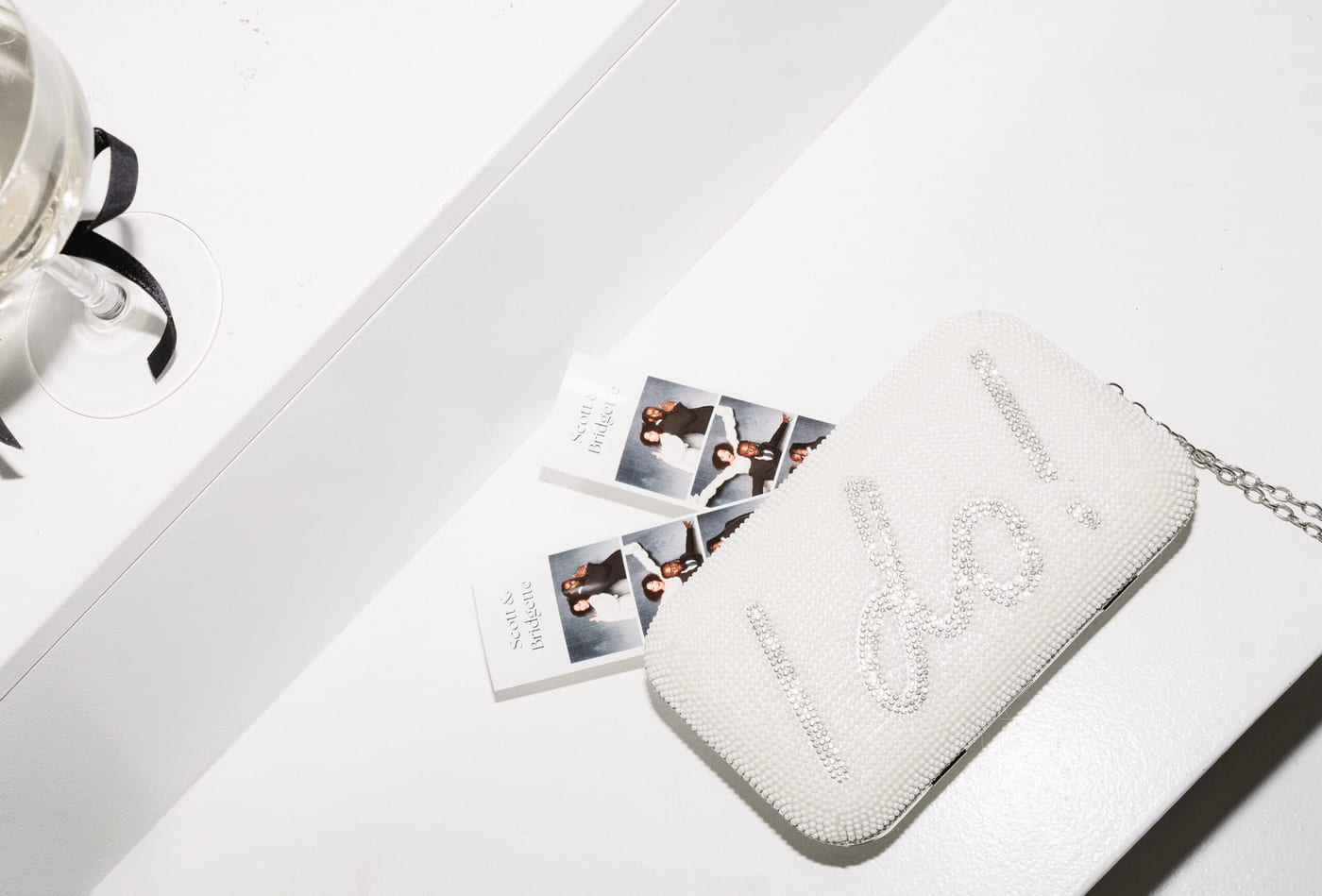 A photo booth print tucked into a clutch to take home